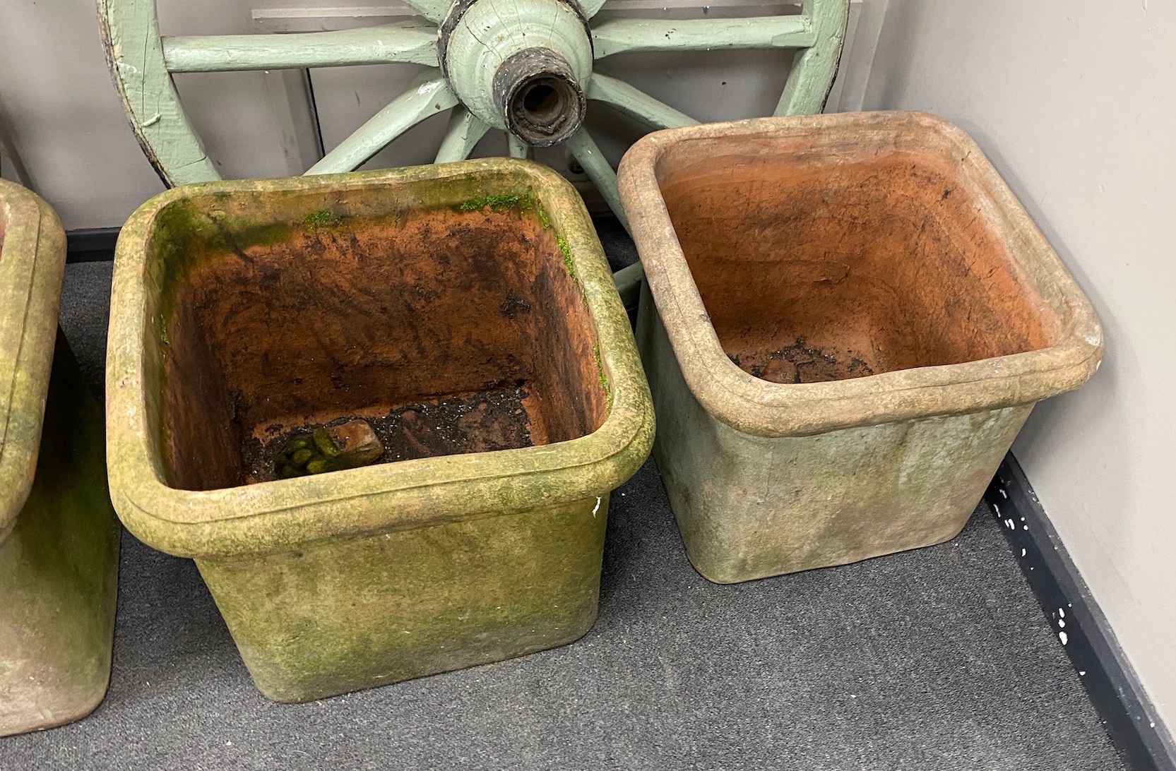 Four terracotta pots with lion's paw feet (two feet missing), width 46cm, height 38cm